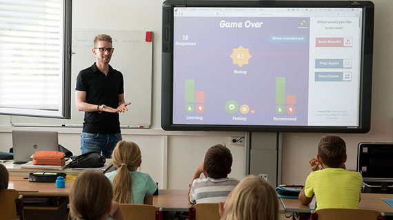 Teacher Presenting Data to Elementary Students